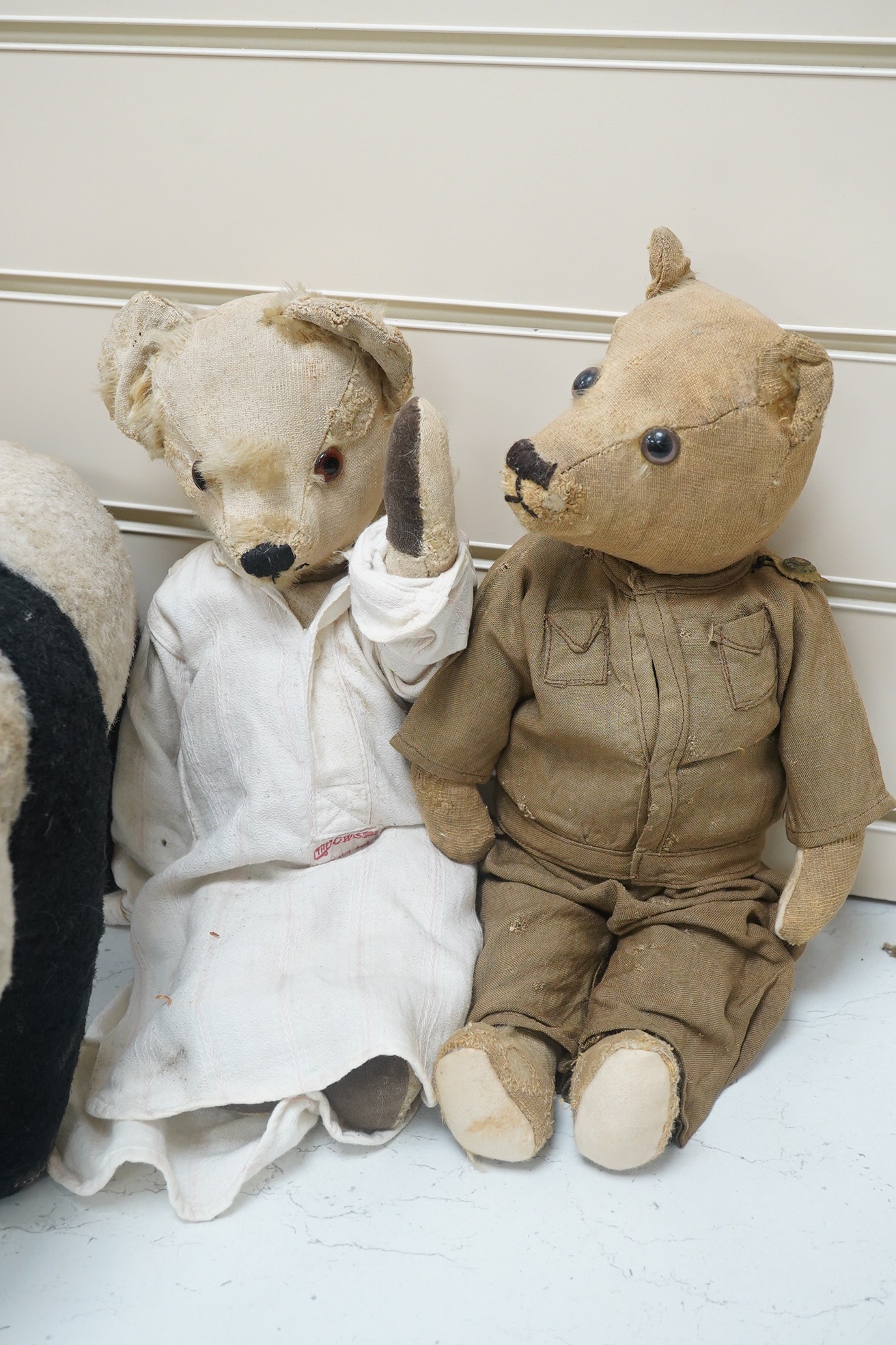 A Panda Invicta bear cotton plush, damage to paw pads, a Merrythought Panda, two other English bears (4). Condition - poor.